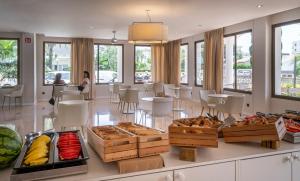 a bakery with a bunch of food on a counter at Bay Hotel in Roses