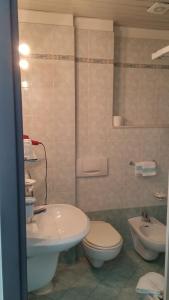 a bathroom with a toilet and a sink at Hotel Smeraldo in Lido di Camaiore