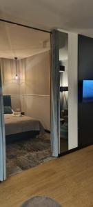 une chambre avec un lit et une télévision dans une pièce dans l'établissement Słoneczne Sarbinowo - Apartament Marynarska 10, à Sarbinowo