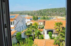 a view of a town with palm trees and buildings at Apartment Leni 2 in Banjole