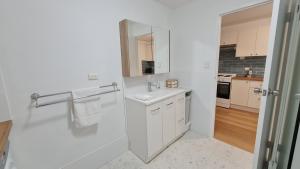 une salle de bains blanche avec un lavabo et un miroir dans l'établissement NEW Coastal Salty Life - 2 bed 1st Floor, à Perth 52 autres photos