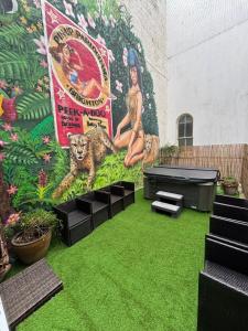 a mural on the side of a building with green grass at The Brighton Parlour with Hot Tub in Brighton & Hove