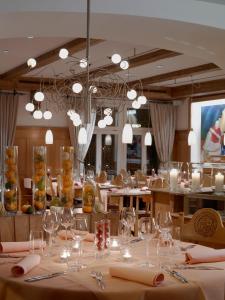 a dining room with a table with wine glasses at Gasthof Löwen in Bubikon