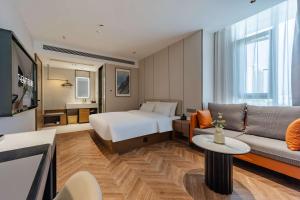 Postel nebo postele na pokoji v ubytování Tingxi Hotel