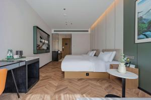Postel nebo postele na pokoji v ubytování Tingxi Hotel