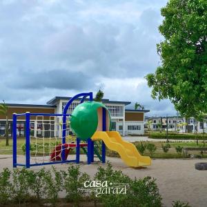 a playground with a slide in a park at Casa Garazi in Calo