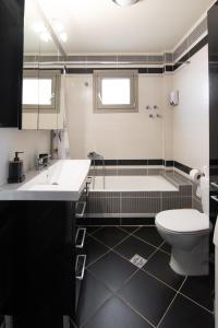 a bathroom with a tub and a toilet and a sink at Alexandra Boutique Residence VILLAS in Alexandroupoli +18 photos