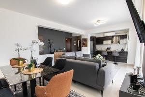 a living room with a couch and a table at Alexandra Boutique Residence VILLAS in Alexandroupoli