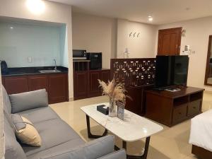 a living room with a couch and a table at THE STAR HOTEL 2 - Phú Mỹ Hưng, Hồ Chí Minh in Ho Chi Minh City