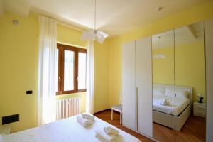 Un dormitorio con una cama blanca y un espejo. en HC - CloHouse Spacious Flat, en Roma