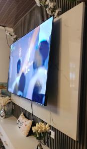a flat screen tv hanging on a wall at Cozy Homely 3 bedroom Holiday Home in Kisii