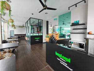 a restaurant with tables and chairs in a room at Swing & Pillows - Bandar Kuantan in Kuantan