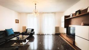 a living room with a couch and a television at Canal Bellavista by Ca-Sa Check in Chioggia