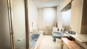 a bathroom with a tub and a sink and a toilet at Canal Bellavista by Ca-Sa Check in Chioggia