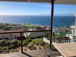 a view of the ocean from the balcony of a house at Oceans Drift Guest House & Self Catering in Simonʼs Town