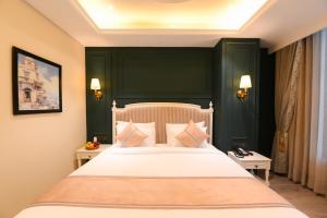 a bedroom with a large bed with green walls at The Sunder Palace-Jaipur City Centre Hotel in Jaipur