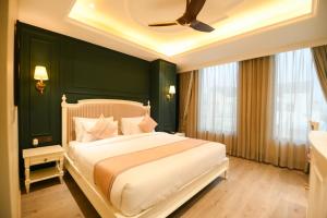 a bedroom with a large bed with a green wall at The Sunder Palace-Jaipur City Centre Hotel in Jaipur