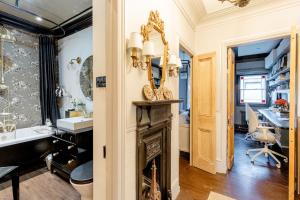 a bathroom with a fireplace and a sink and a desk at Stylishly Designed Private Home in Central Windsor in Windsor +28 photos