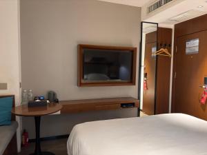 Ένα ή περισσότερα κρεβάτια σε δωμάτιο στο Borrman Hotel Guangzhou East Station Meihuayuan Subway Station Branch +1 φωτογραφίες