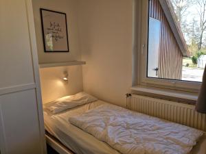 Ein Bett oder Betten in einem Zimmer der Unterkunft Urlauberdorf Haus 31d