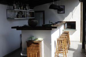 a kitchen with a counter and some stools in it at Complex Fretly in Gorni Dŭbnik