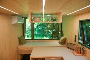 a small room with a window in a tiny house at Green Tiny Village Harz - Tiny House Nook 20 in Osterode
