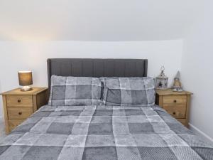 a bedroom with a bed with two night stands at Hemdin Cottage in Pickering