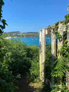an old building with a view of a body of water at ANNA Apartment, Downtown and Port on foot! in Cancale +12 photos