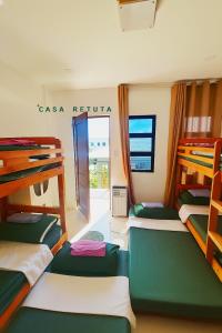 a room with four bunk beds and a window at Casa Retuta - Guest House for Groups in San Vincente