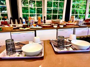a kitchen with bowls and plates on a counter at Moulin du soustre in Cavagnac