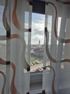 a window with a view of a city at D&D Studio Apartment in Velika Gorica +2 photos