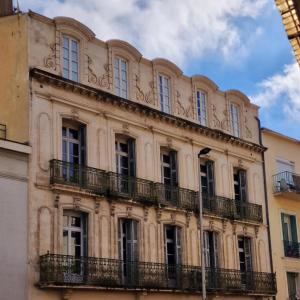 a building with balconies on the side of it at Apartment Joie de Vivre in Béziers