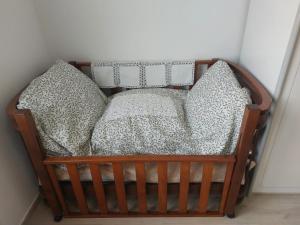 a wooden crib with pillows in a room at B&B Straccialena in Colcerasa