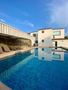 a swimming pool in front of a villa at Quinta do Miradouro in Portalegre