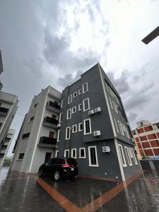 Un coche negro aparcado delante de un edificio en iSoZo Luxury Stays Apartment 2, en Ikeja