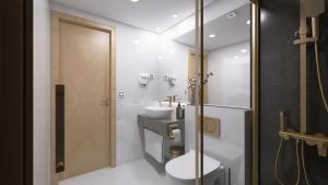 a bathroom with a toilet and a sink and a shower at Negresco Plaza Mayor in Madrid +20 photos
