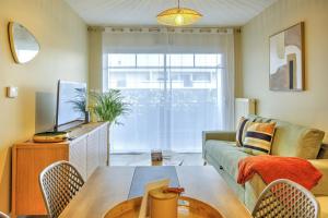 a living room with a couch and a table at Bonbini - 5min du Port de la Teste in La Teste-de-Buch