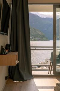 a room with a window with a view of the water at Havila Hotel Geiranger in Geiranger