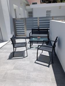 twee zwarte banken en een tafel in een kamer bij Platanou 21 Apartments in Kremasti