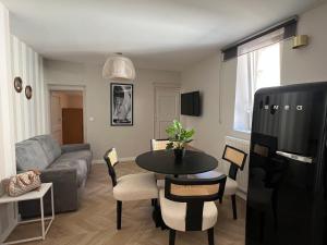 a living room with a couch and a table at L Esperance rue du paquier in Annecy