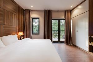 ハノイにあるBelvilla near West Lake Hanoi, Truc Bach Lake formerly Le Grand - The Central Parkの大きな白いベッドと窓のある寝室