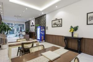 a dining room with tables and chairs in a restaurant at Belvilla near Hoan Kiem Lake, Old Quarter formerly Le Grand - The Tryst in Hanoi