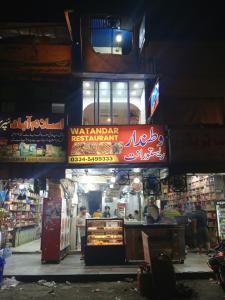 a market with a sign that says wahammad restaurant at AL AQSA SUiTES Guest House Islamabad in Islamabad