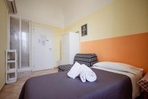 a bedroom with a bed with two towels on it at B&B Toscana in Pisa