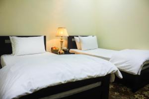 Ένα ή περισσότερα κρεβάτια σε δωμάτιο στο Starlit Hotel - Gilgit
