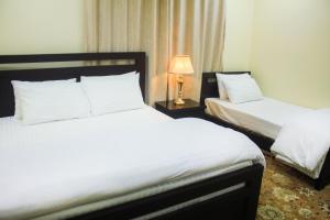 Ένα ή περισσότερα κρεβάτια σε δωμάτιο στο Starlit Hotel - Gilgit