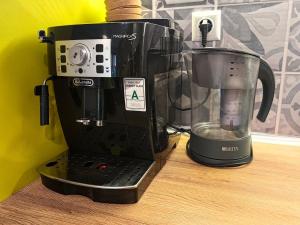 a coffee maker sitting on a counter next to a blender at Kalina Apartment Kazanlak in Kazanlŭk