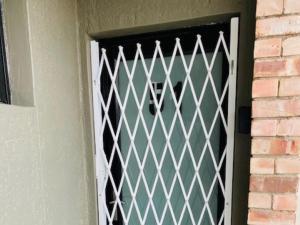 a door with a lattice pattern on it at Wild Olive at 51 in Windhoek