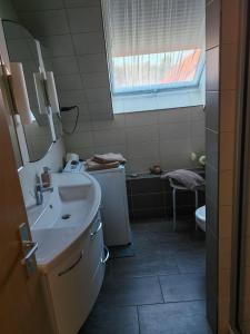 a bathroom with a sink and a toilet at Ferienwohnung-mit-Balkon in Pinnow