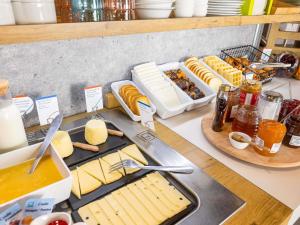 a table with cheese and other food items on it at ibis budget Angoulême Centre in Angoulême